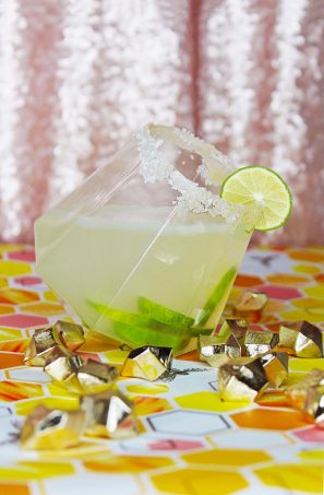 A homemade zesty citrus (lime & orange!) margarita recipe enhanced with raw honey for the perfect tart alcoholic drink on Home in High Heels